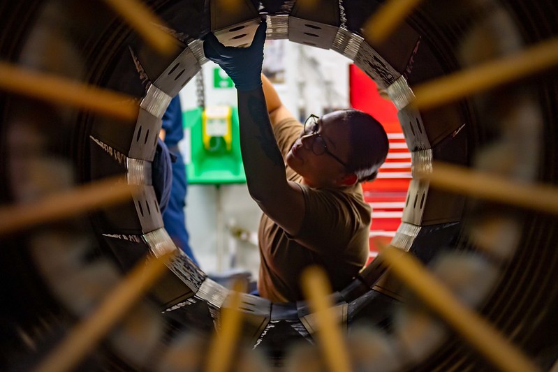 Aviation Machinist conducts maintenance on an afterburner CC-BY-NC https://www.flickr.com/photos/compacflt/51319755467/